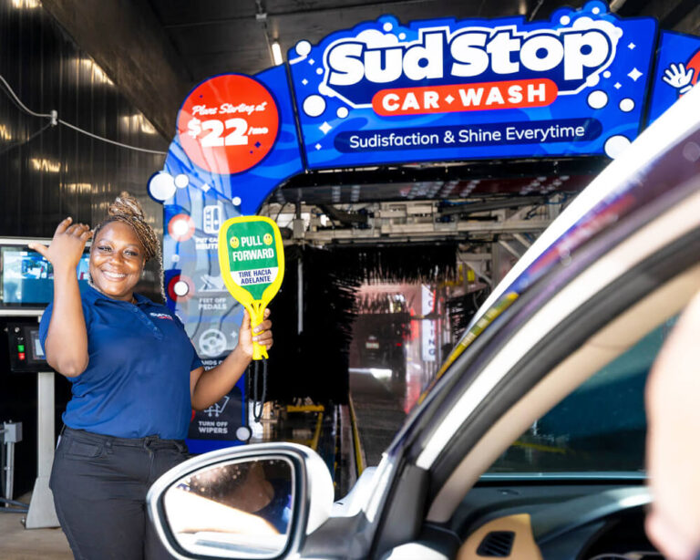 Team Member Guiding Car Into Wash Tunnel